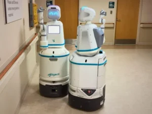 Two Moxi robots waiting to receive and execute tasks.Diligent Robotics
